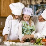 Mother teaching children how to cook